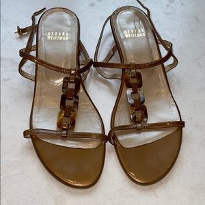 Stuart Weizman wedge sandal with horn accents.